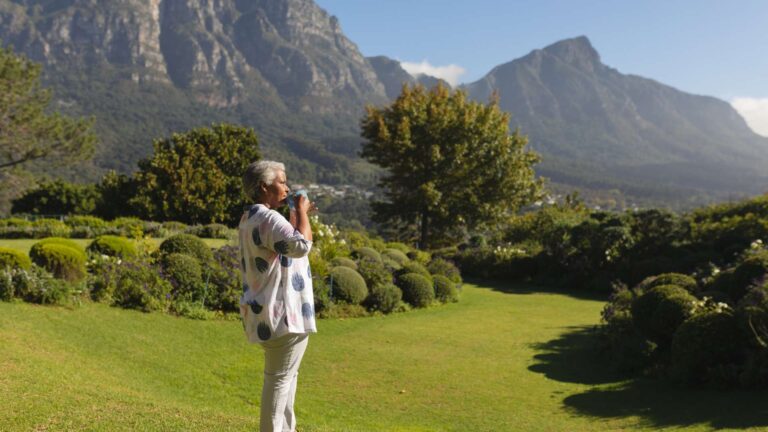 Elderly woman enjoying a cup of tea and the views of Cape Town, THREE43 on B