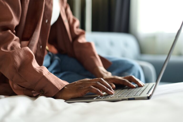 Black Girl Typing on Laptop in Hotel
